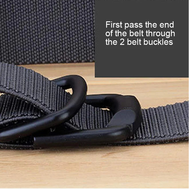 Black belt with two belt buckles on a wooden surface