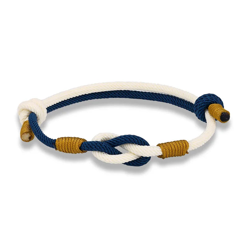 Nautical-style bracelet with blue, white, and gold ropes on a white background
