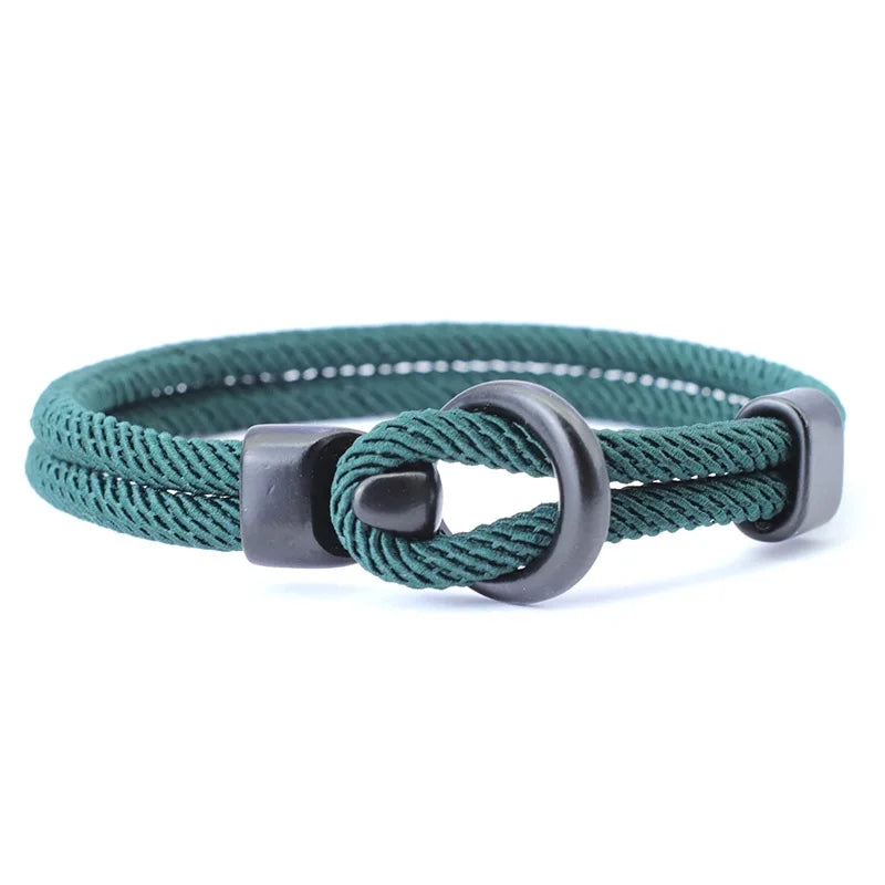 Teal braided bracelet with a gray metal clasp on a white background