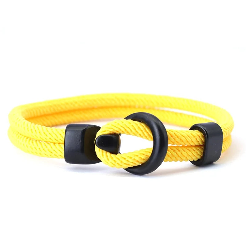Yellow bracelet with black clasp on a white background