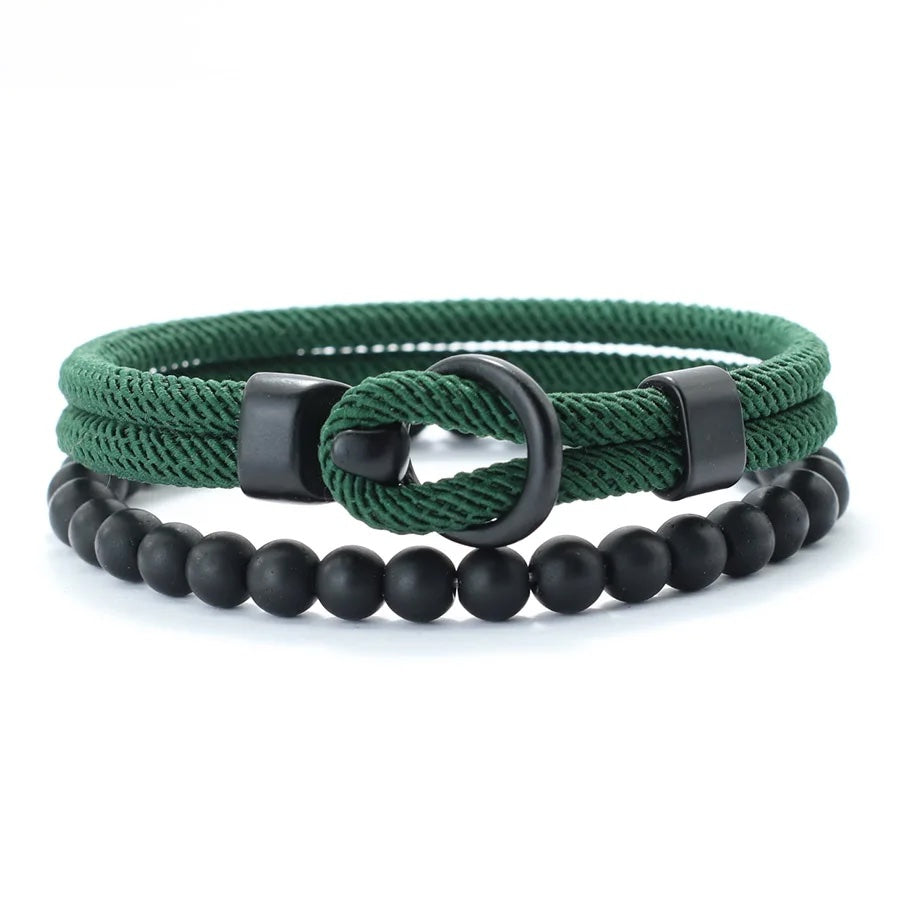Two bracelets, one green rope-style and one black beaded, on a white background