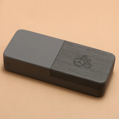 Gray yoga block with a textured surface on a beige background