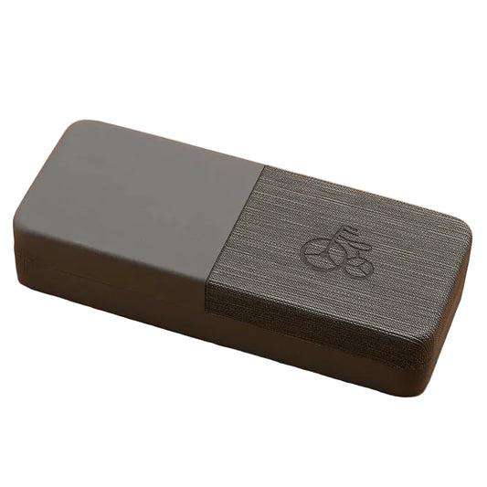 Gray yoga block with a textured surface on a beige background