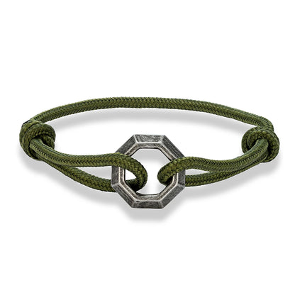 Green bracelet with a silver hexagonal clasp on a white background